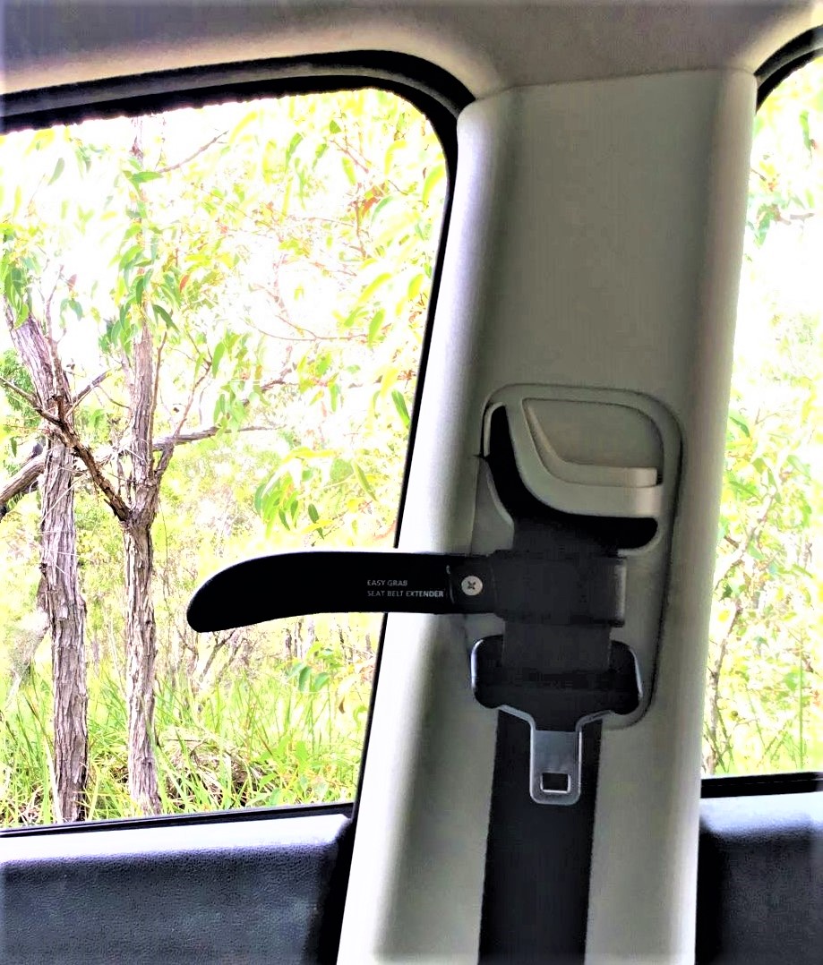 Easy Grab seat belt extender fitted to a car seat belt above the buckle